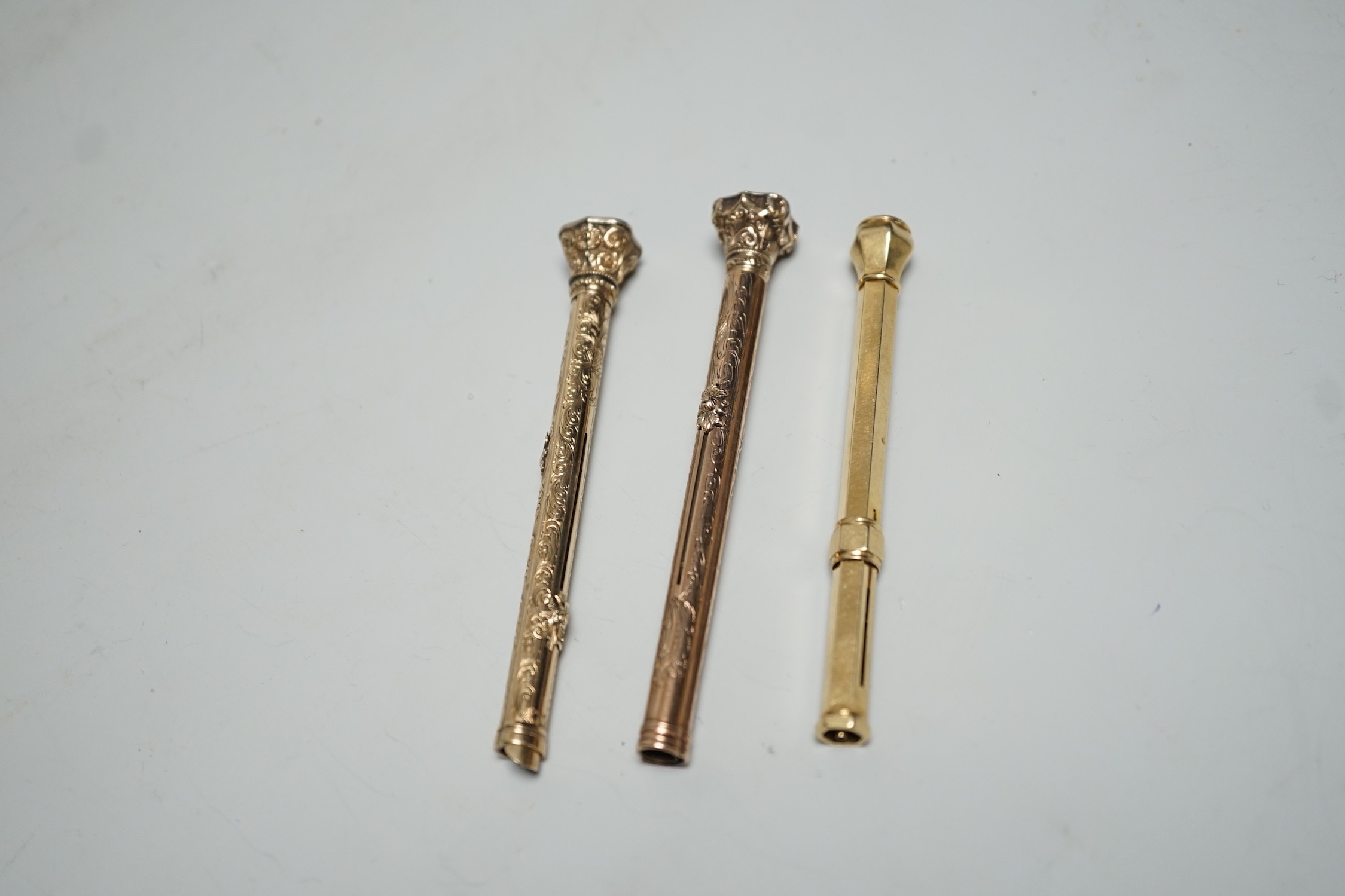Three assorted yellow metal overlaid and gem set propelling pencils including Mordan